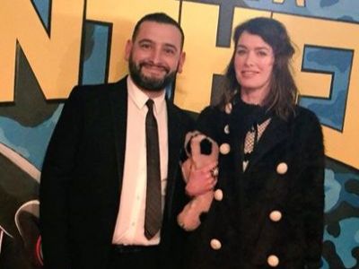 Dan Cadan is in a black suit and Lena Headey is wearing a black jacket.